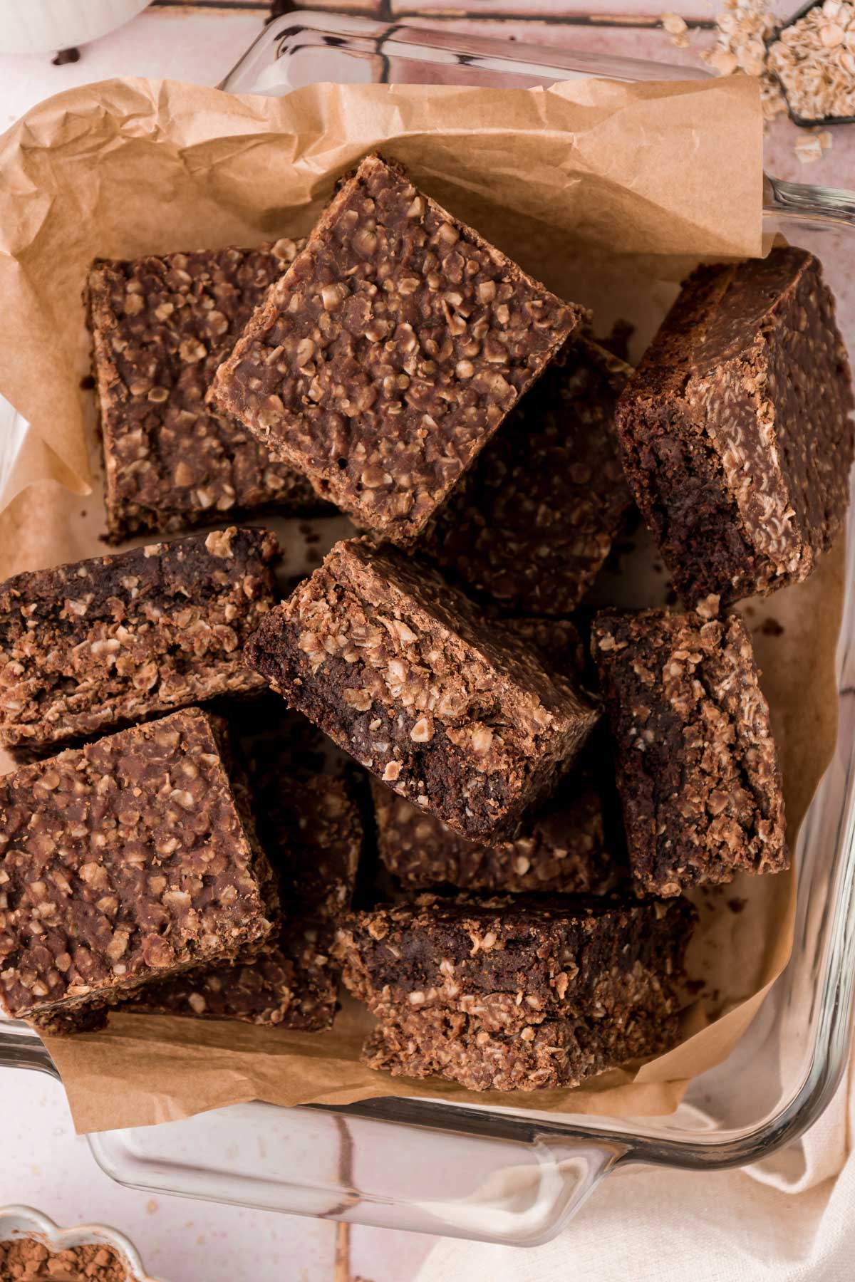 Overhead photo of no bake cookie brownies in a pan with parchment paper.