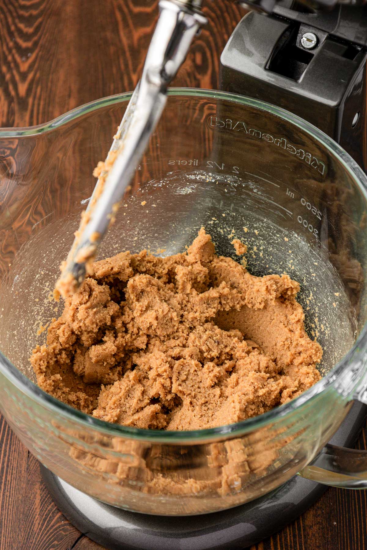 Butter and sugar creamed together in a glass stand mixer bowl.