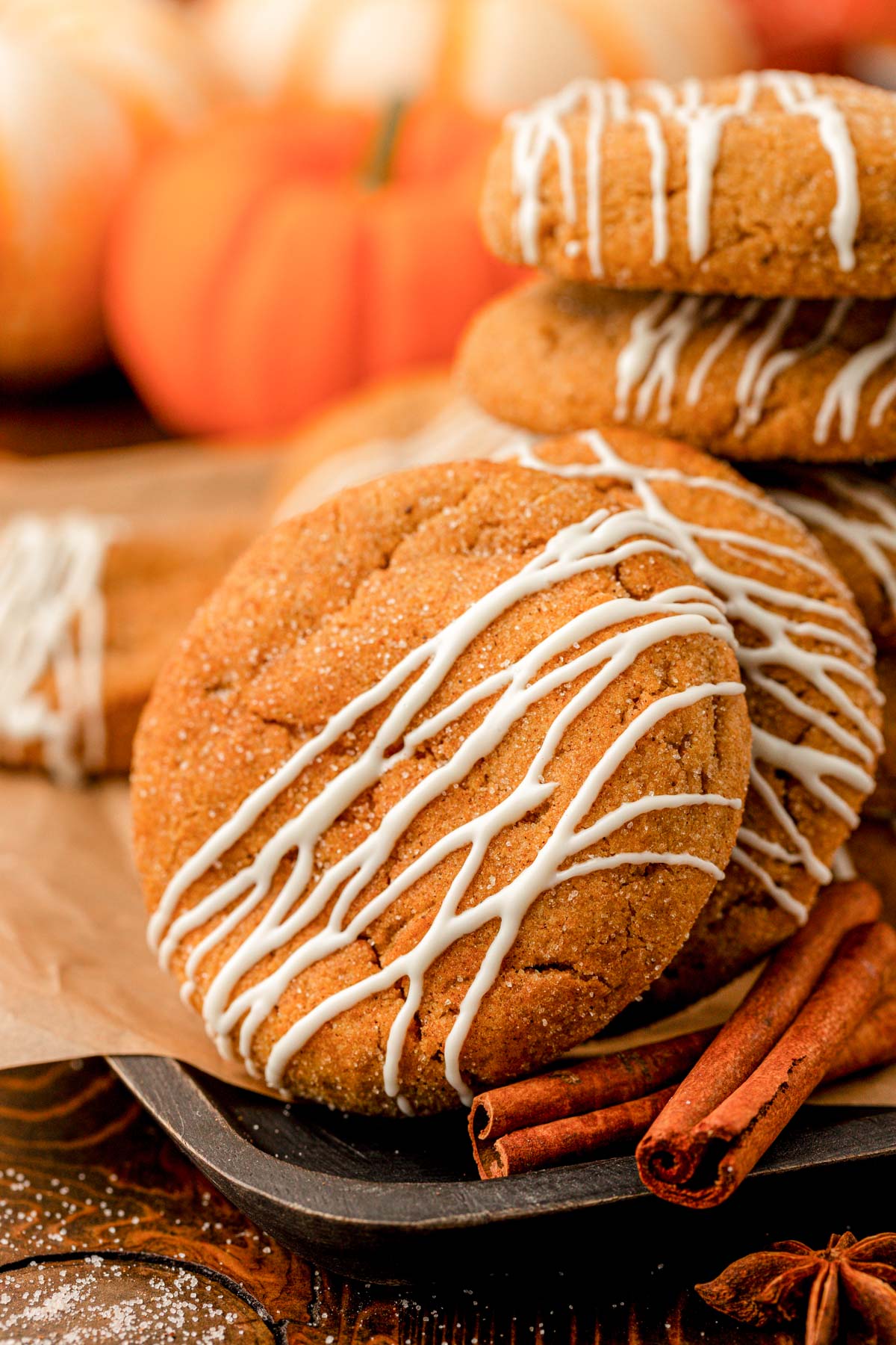 Close up of pumpkin cookies with white chocolate drizzle.