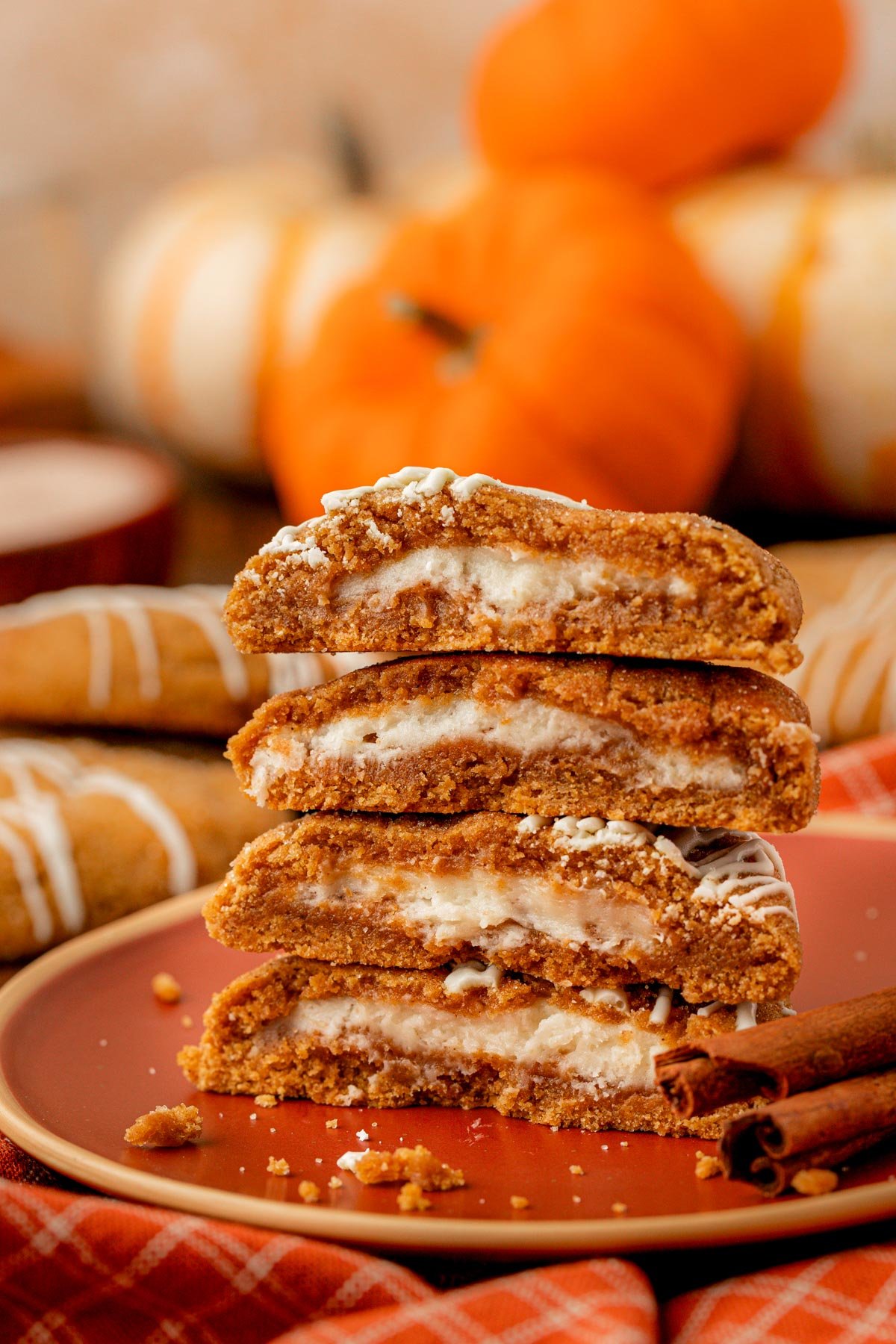 A stack of pumpkin cream cheese cookies on a table.