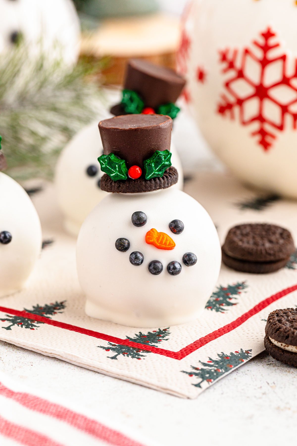 Close up of an Oreo Ball decorated to look like a snowman.