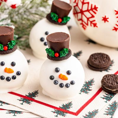 Close up of snowman themed Oreo Balls on a festive napkin.