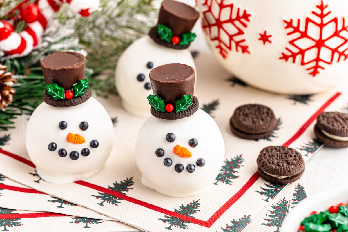 Close up of snowman themed Oreo Balls on a festive napkin.