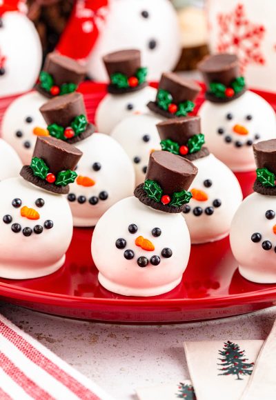 Snowman Oreo Truffles on a red plate.