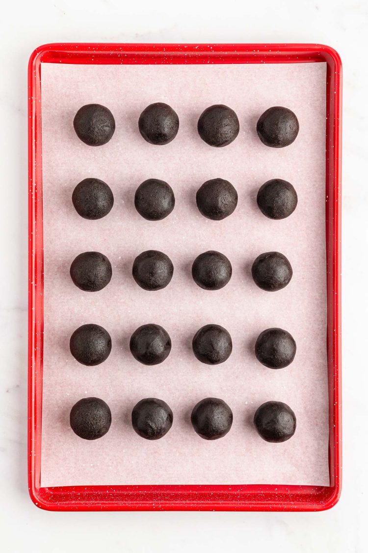 Oreo Balls shaped and on a baking sheet ready to chill.