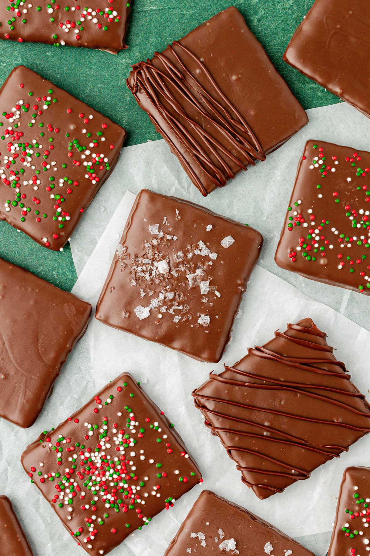 Chocolate covered graham crackers on parchment paper.