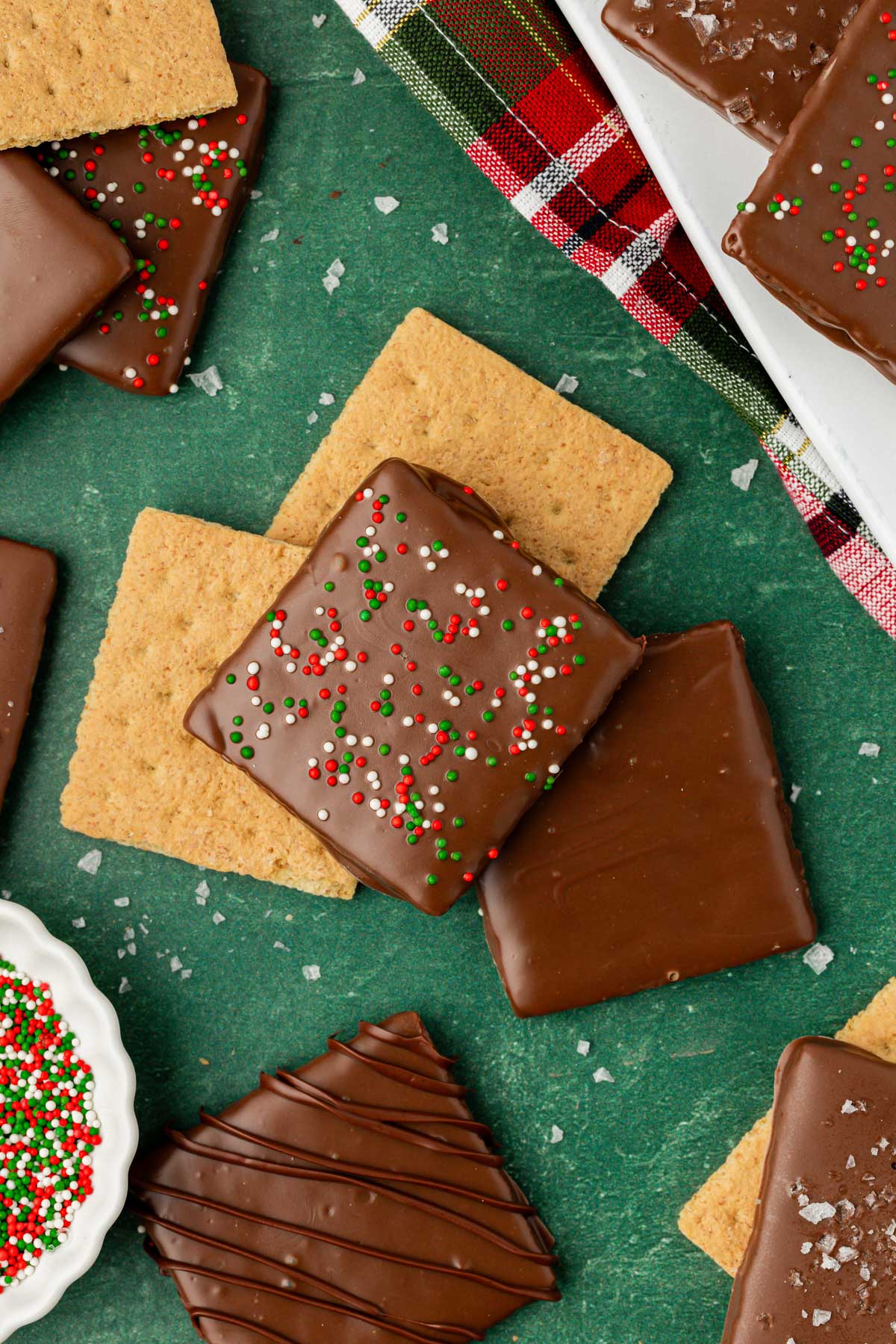 Christmas chocolate coated graham crackers on a green table.