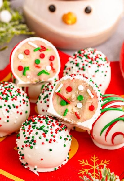 Close up photo of christmas cookie truffles on a plate, One split in half to show the inside.