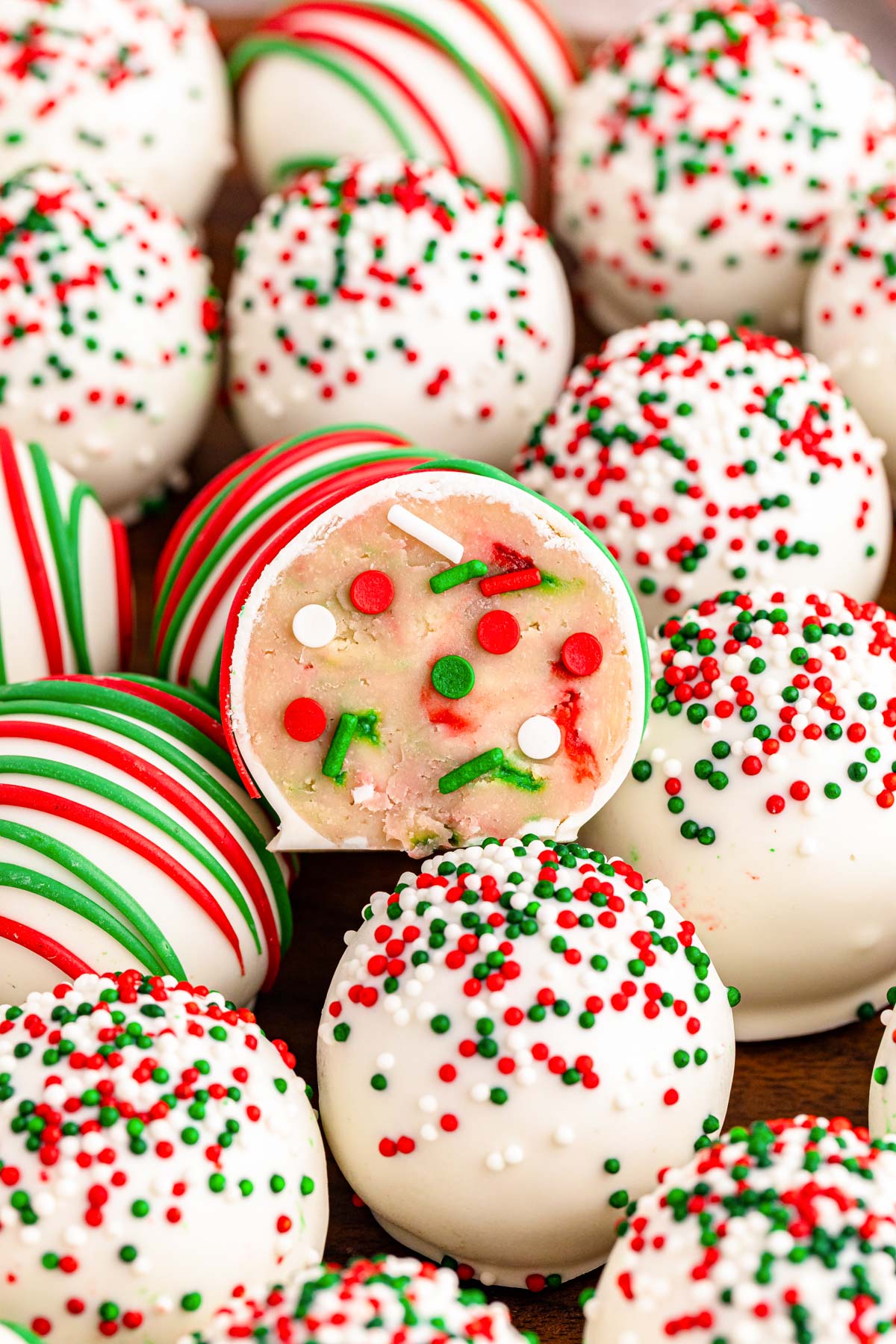 Close up of Christmas Sugar Cookie Truffles piled on a plate.