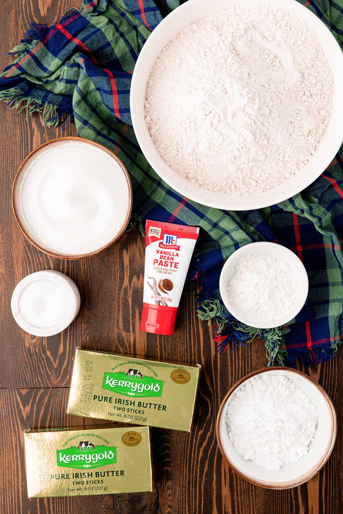 Overhead photo of ingredients to make shortbread cookie bars on a wooden table. 