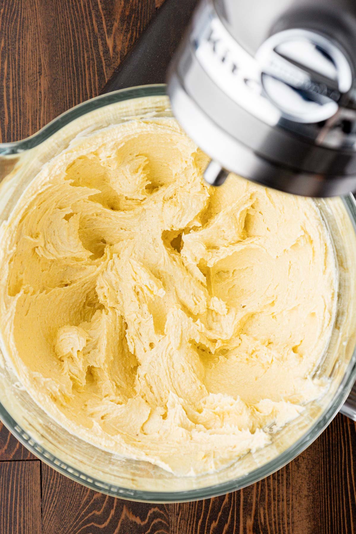 Butter and sugar creamed together in a mixing bowl.