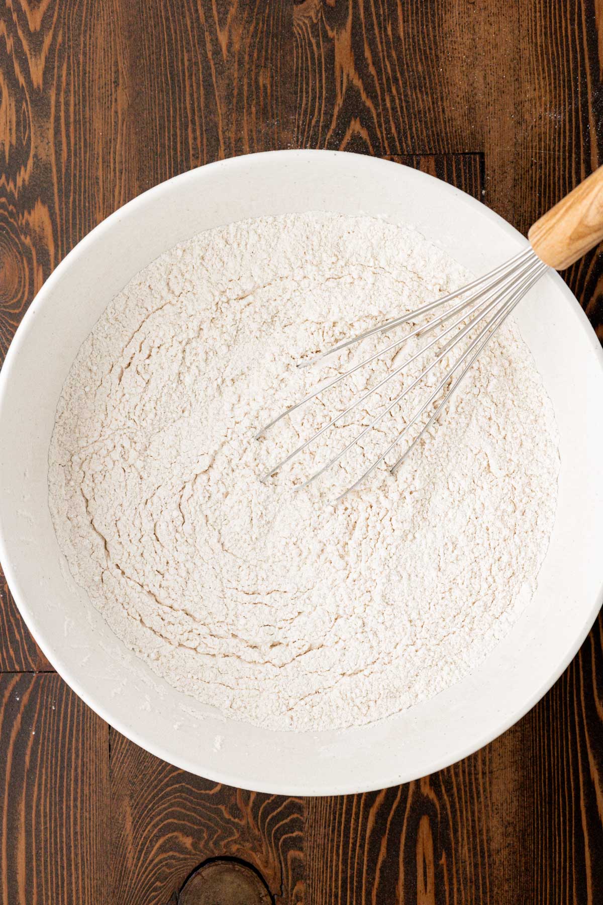 Overhead photo of a bowl of dry ingredients being whisked together to make shortbread.
