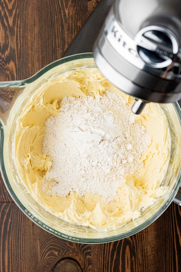 Dry ingredients being added to creamed butter and sugar to make shortbread cookies.