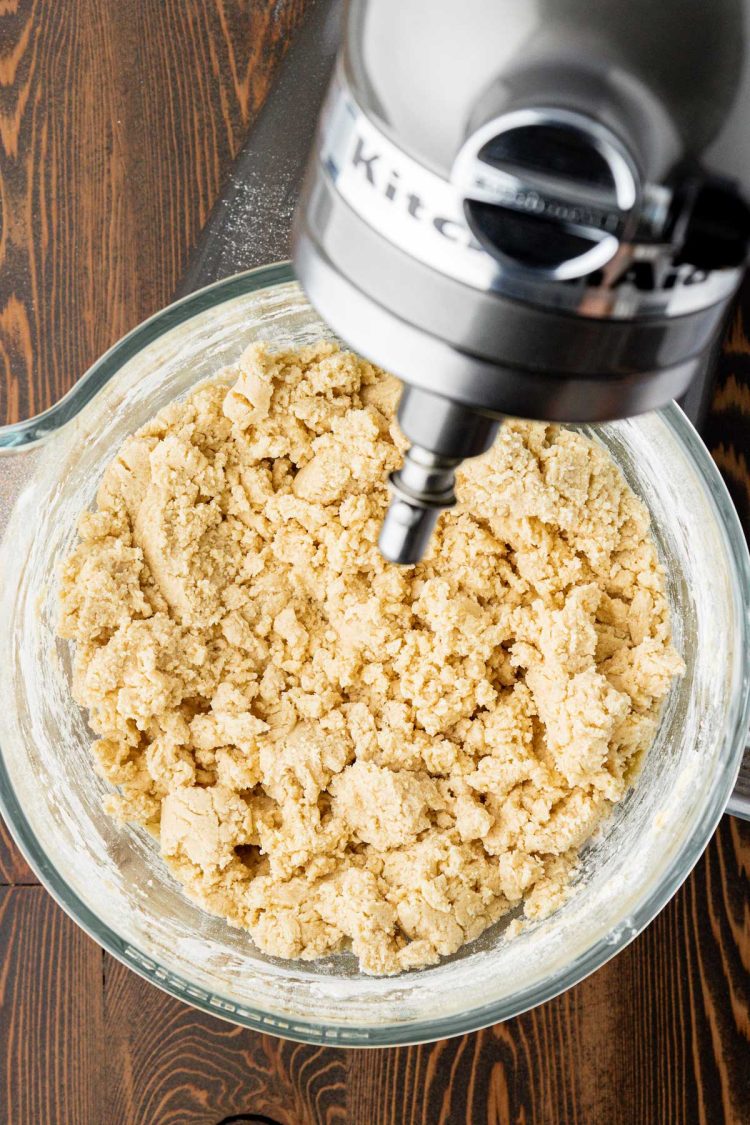 Overhead photo of a mixing bowl filled with crumbly shortbread dough.