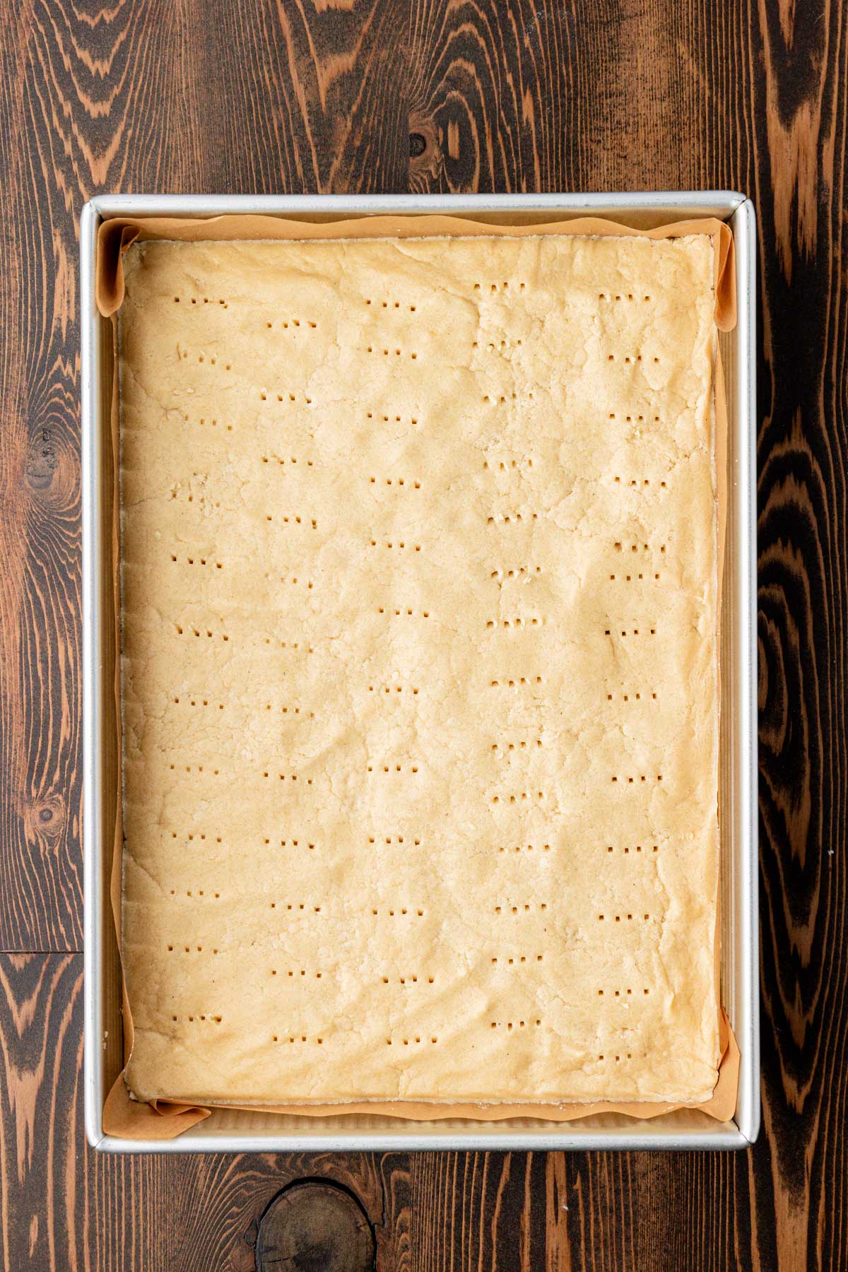 Overhead photo of a pan of shortbread cookie dough ready to bake.