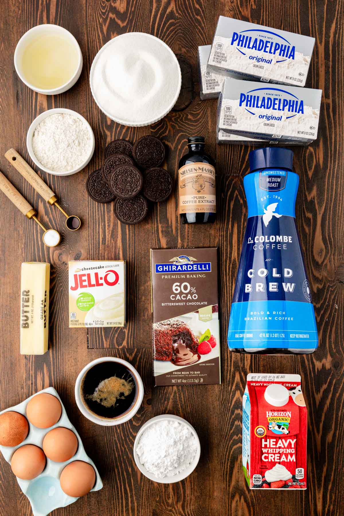 Overhead photo of ingredients on a wooden table to make coffee cheesecake.