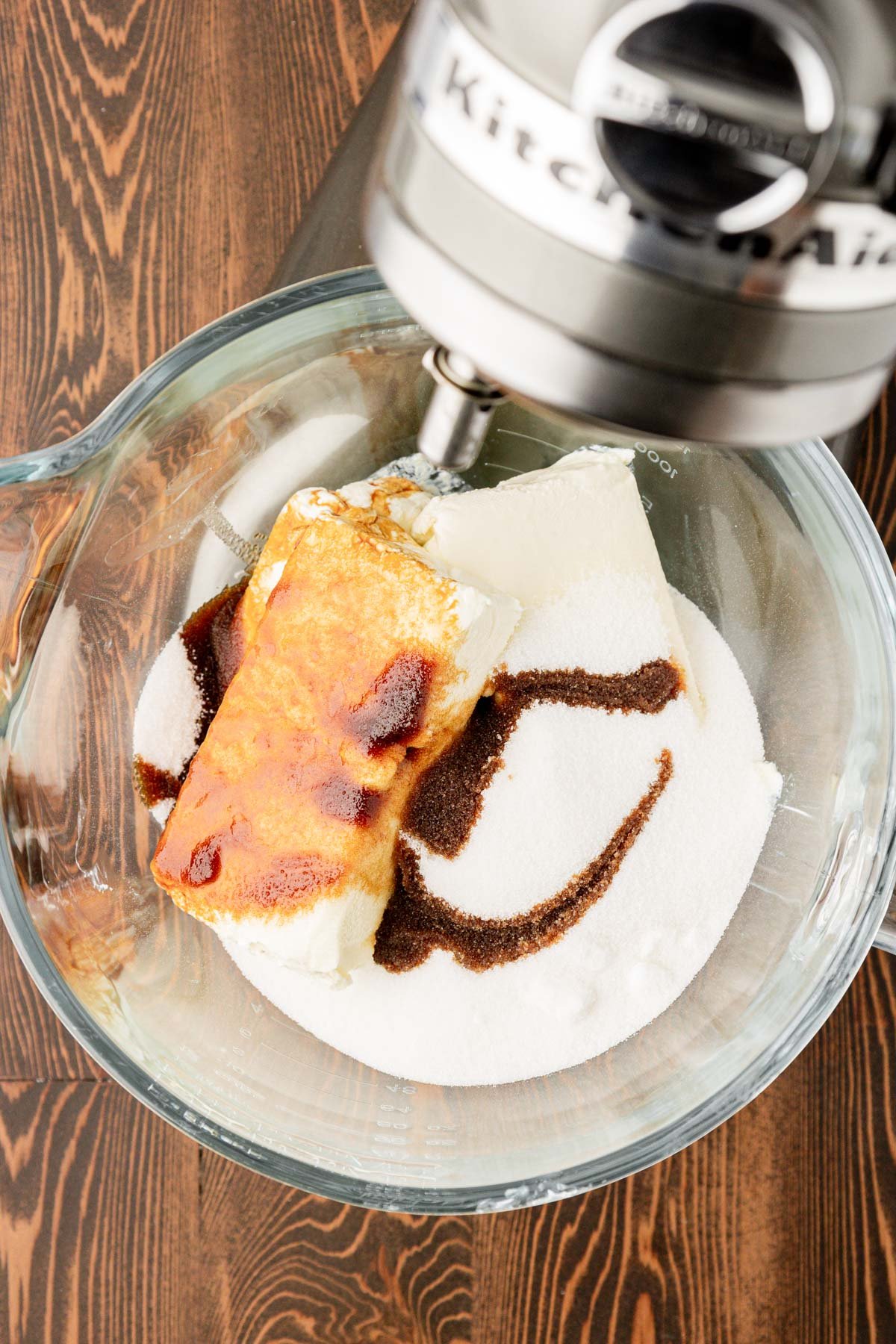 Ingredients for coffee cheesecake in a glass mixing bowl.