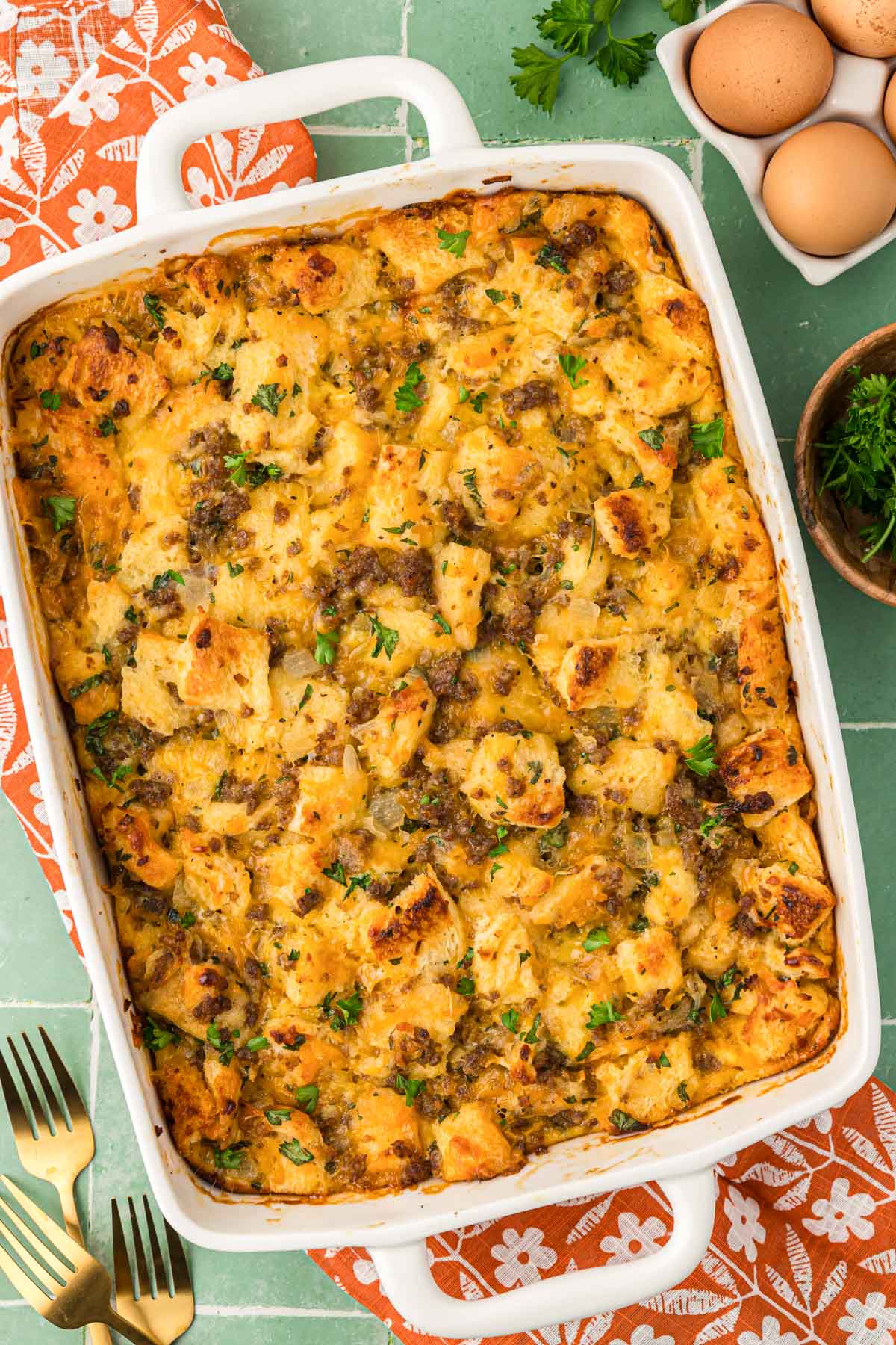 Overhead photo of Sausage Breakfast Strata on a green surface.