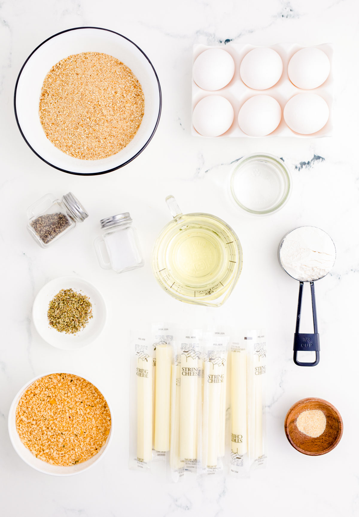 Overhead photo of Mozzarella Stick Ingredients on a marble surface.