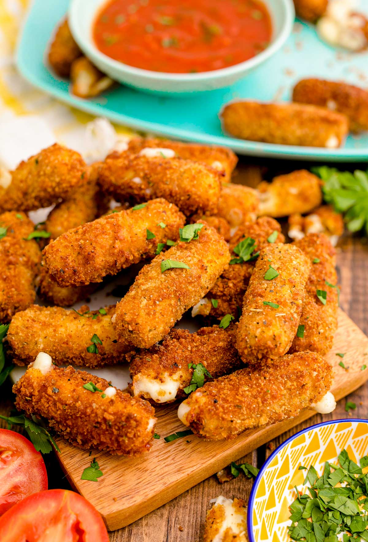 Mozzarella Sticks on a wooden board.