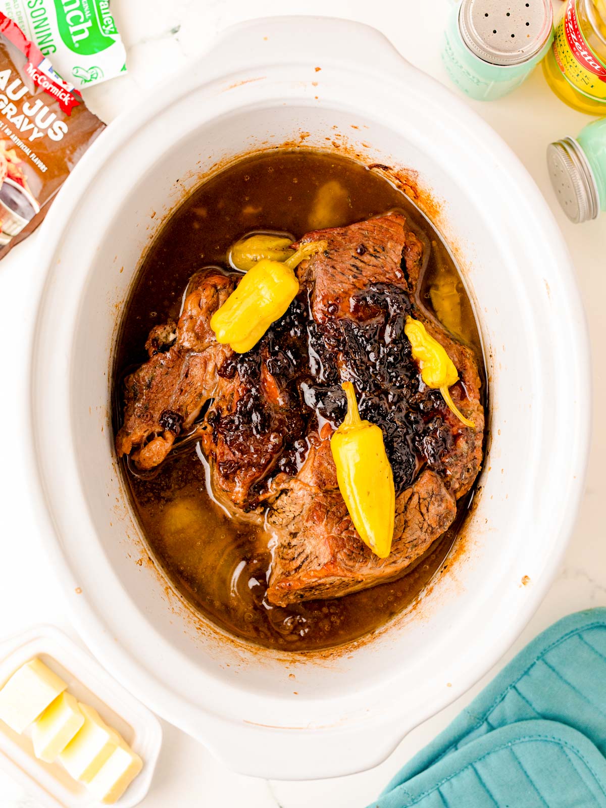 Mississippi pot roast in a slow cooker ready to be shredded.