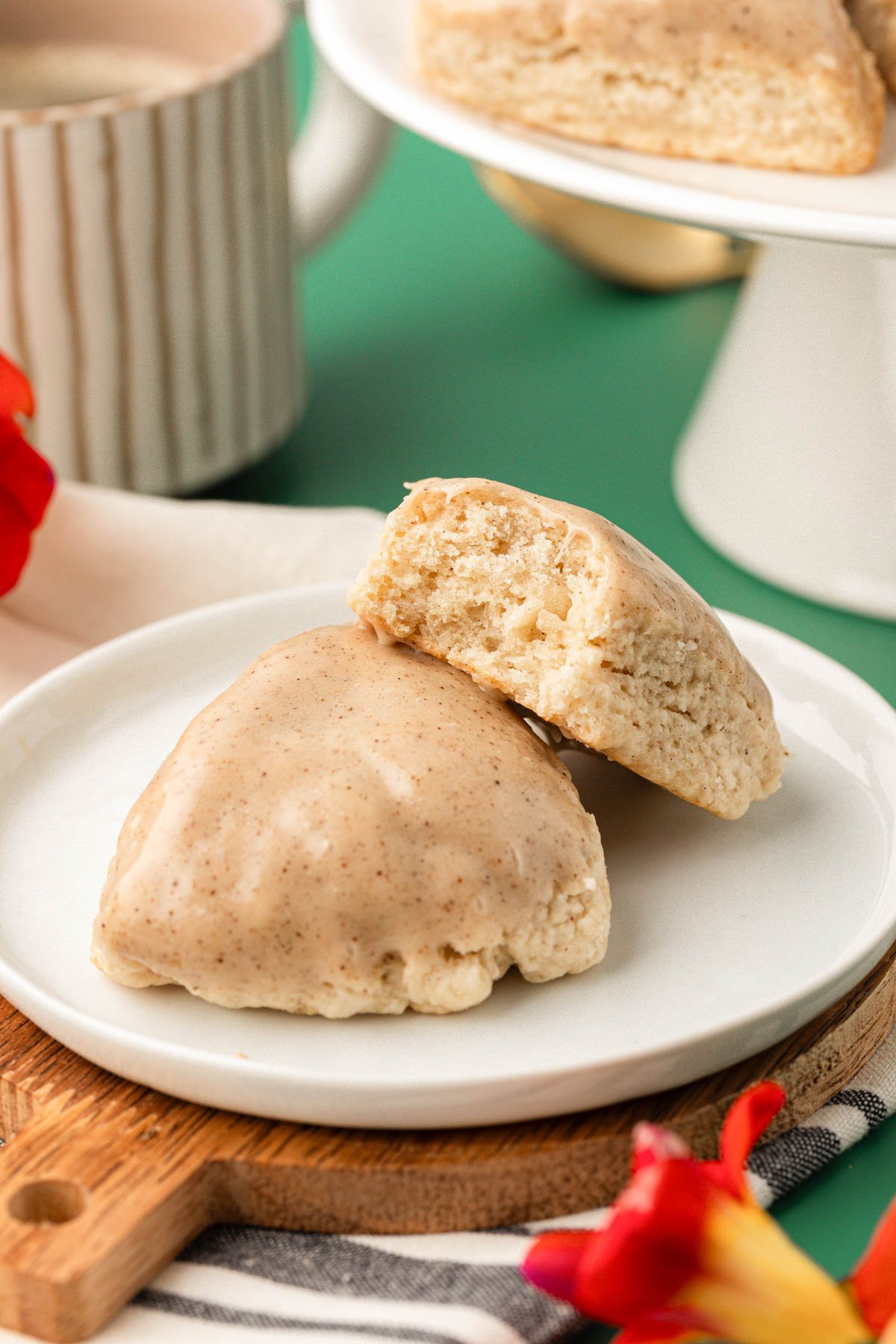 A small white plate with two petite vanilla bean scones on it.