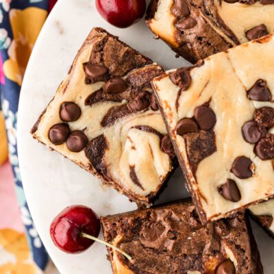 Overhead photo of cheesecake brownies on a cake stand.