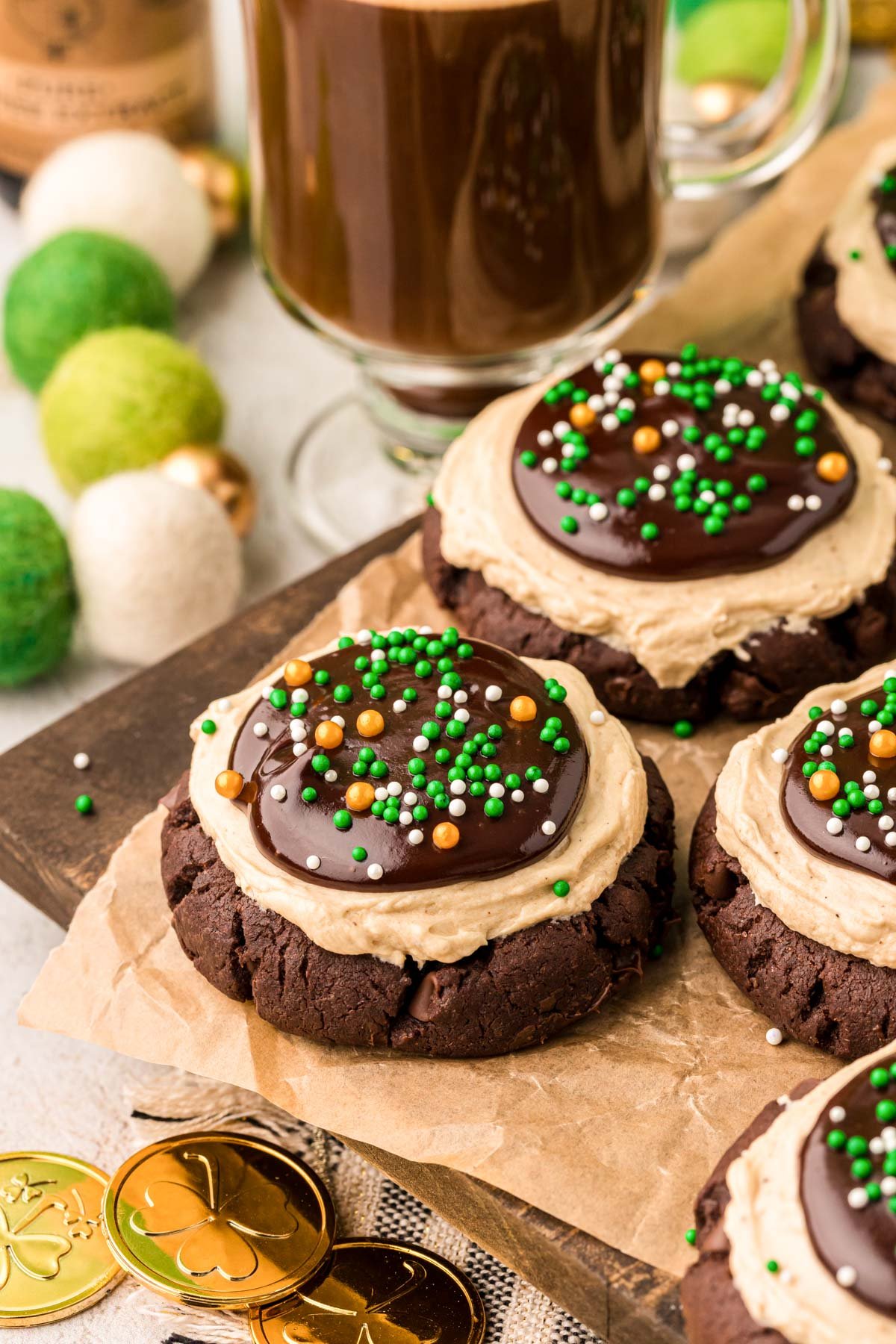 Irish Coffee Frosted Cookies on a cutting board with parchment paper. 