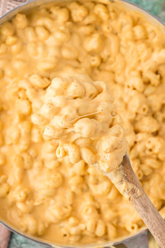 Overhead photo of creamy mac and cheese being spooned out of a skillet.