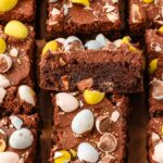 Sliced cadbury egg brownies on a serving board.