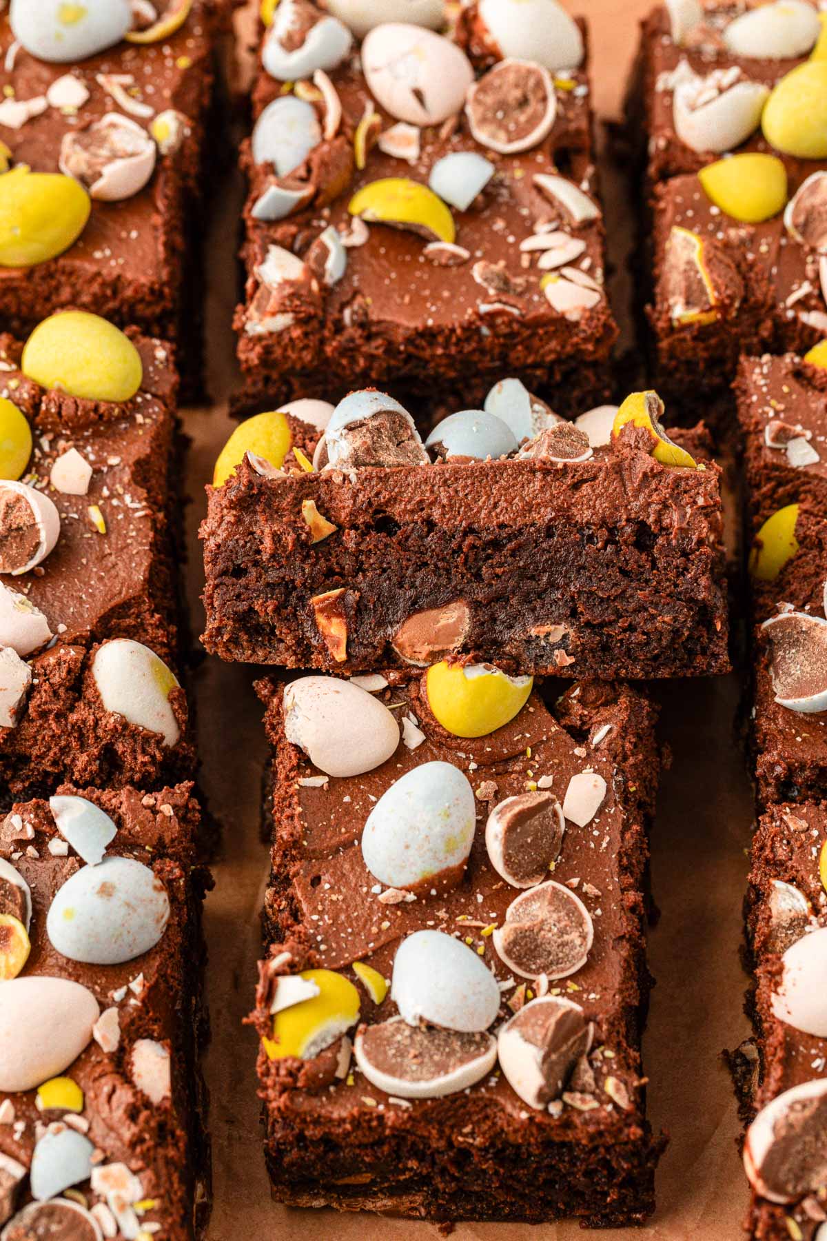 Sliced cadbury egg brownies on a serving board.