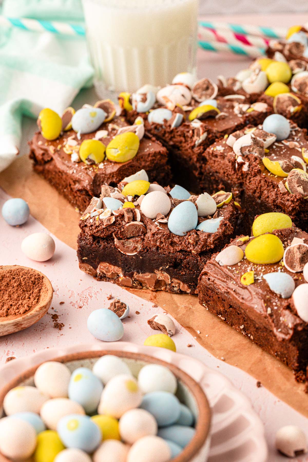 Brownies cut up on a piece of parchment paper.