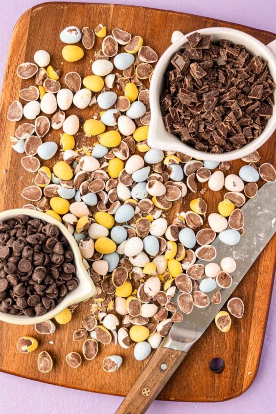 Cadbury Eggs chopped on a cutting board.