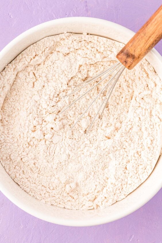 Dry ingredients to make cookies being whisked together in a bowl.