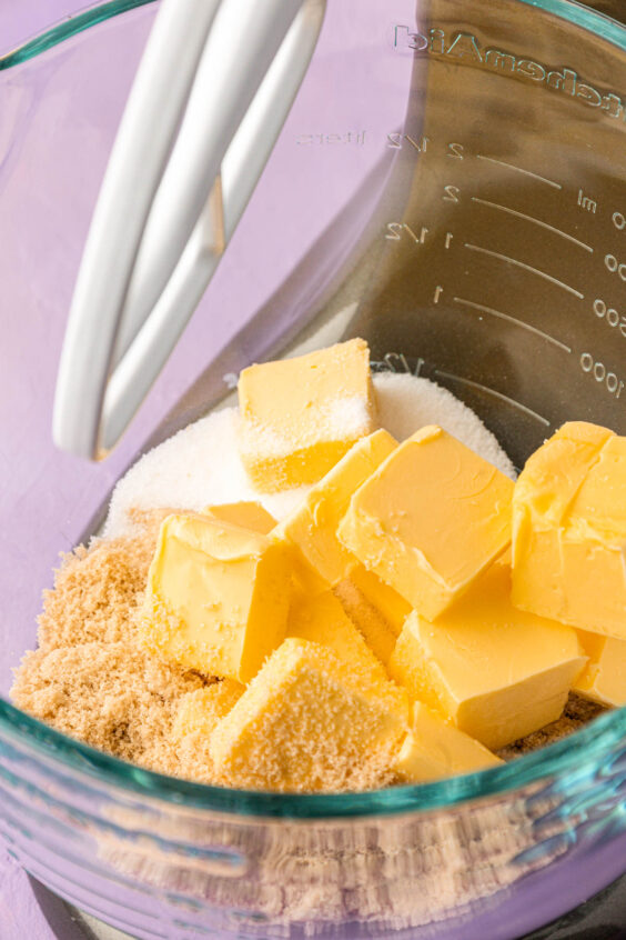 Butter and sugars ready to beat together in a stand mixer bowl.
