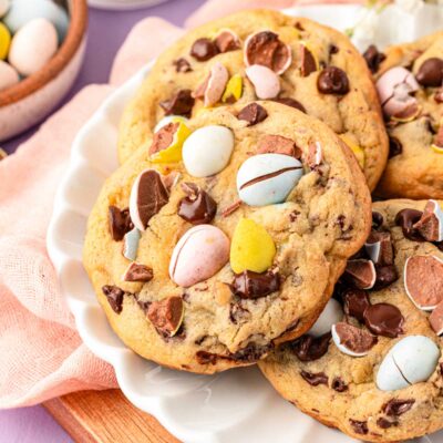Close up of cadbury mini egg cookies on a white plate.