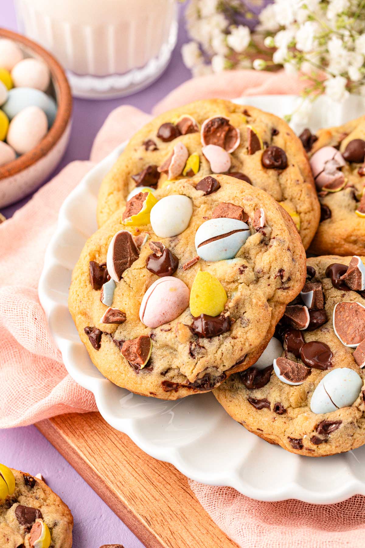 Close up of cadbury mini egg cookies on a white plate.