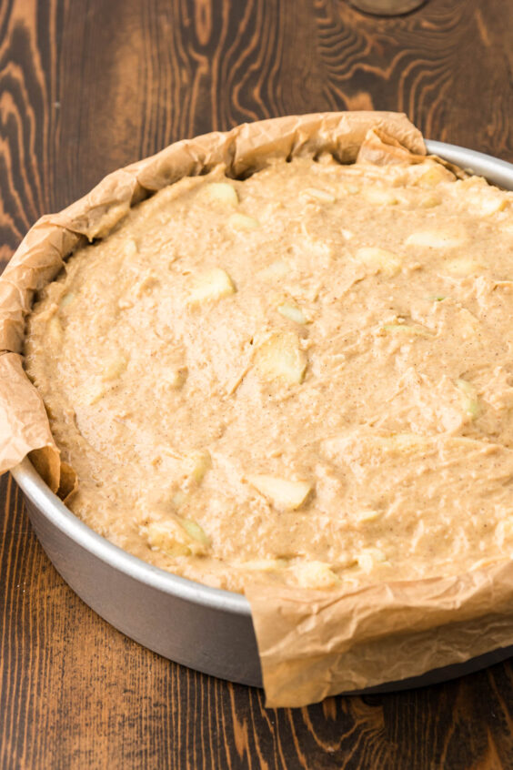 Apple cake batter in a round pan.