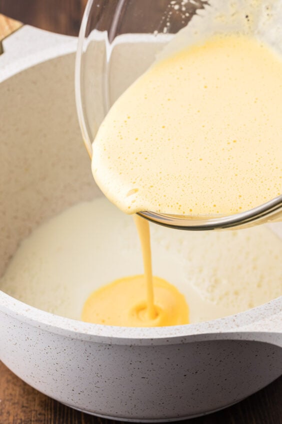 Eggs being whisked into warm milk.