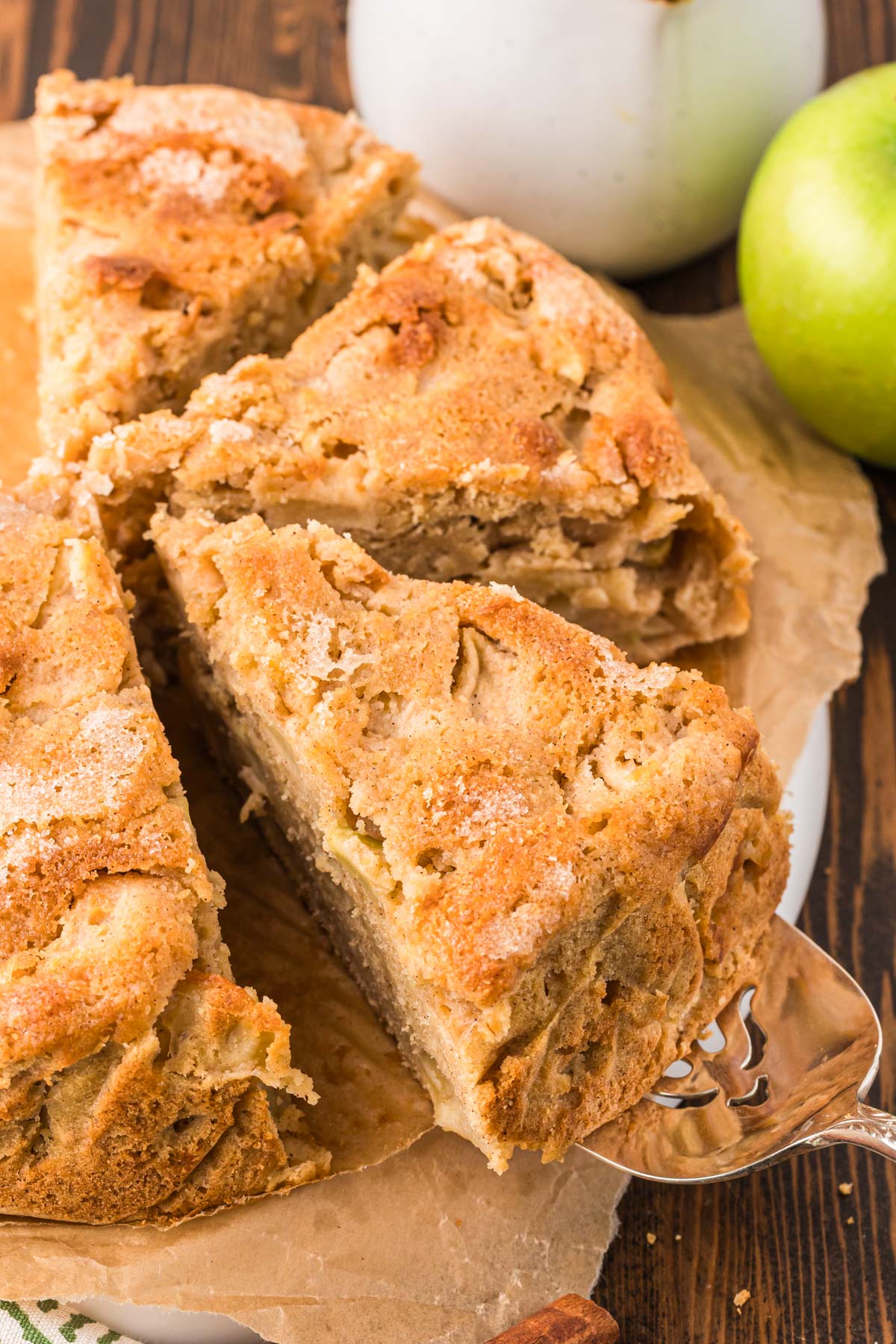 A slice of Irish Apple Cake being pulled from the whole cake.