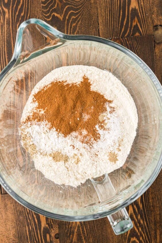 Dry ingredients to make cake in a glass bowl.