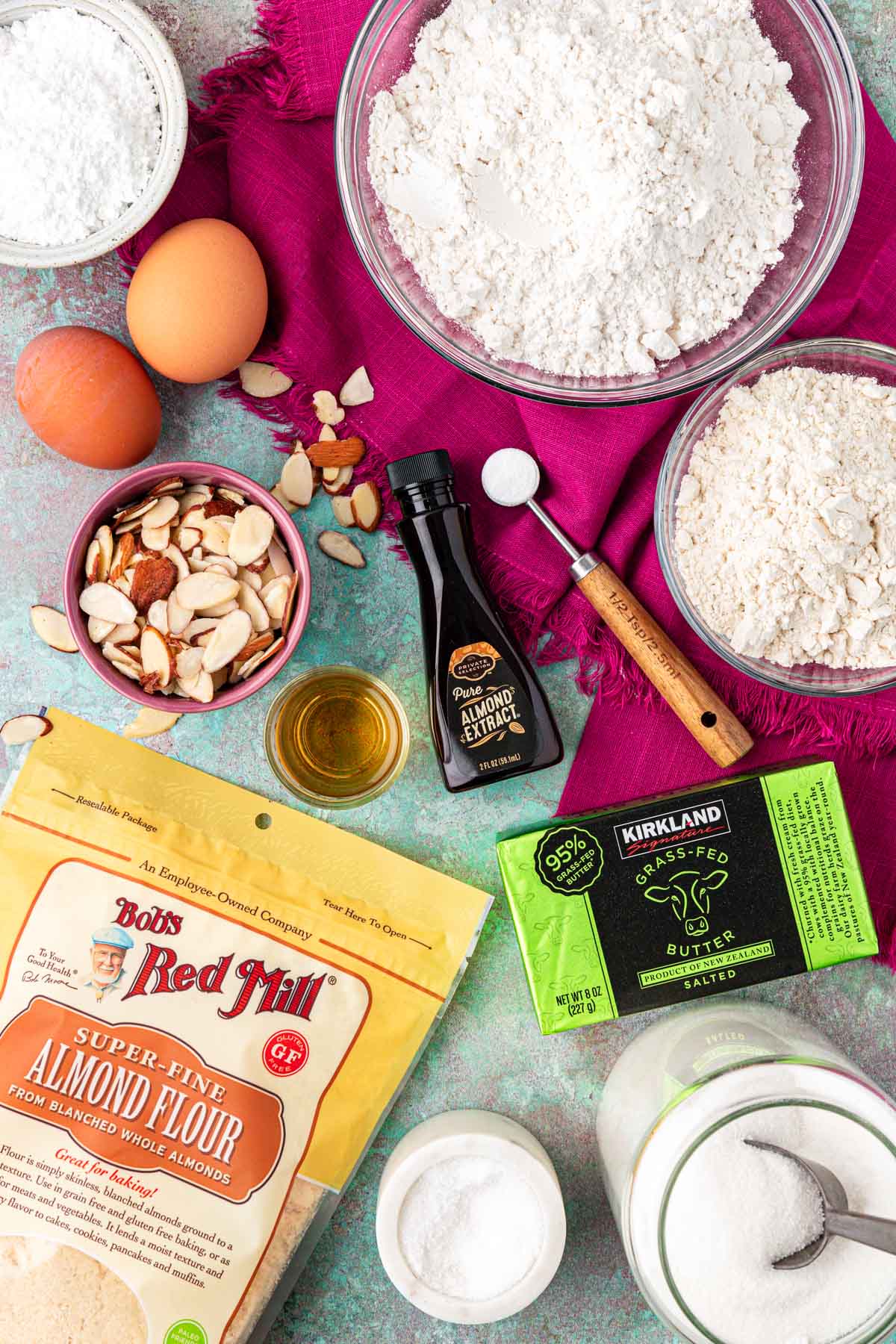 Overhead photo of ingredients to make almond croissant cookies on a table.