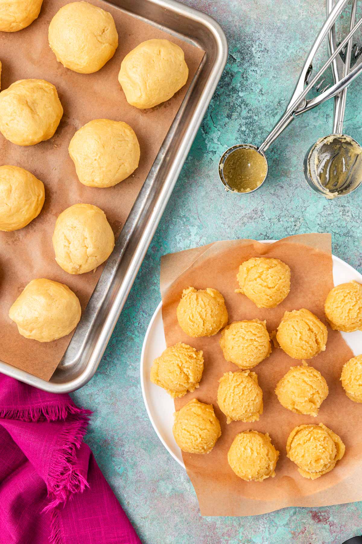 Overhead photo of balls of cookie dough and filling on a plate and pan.