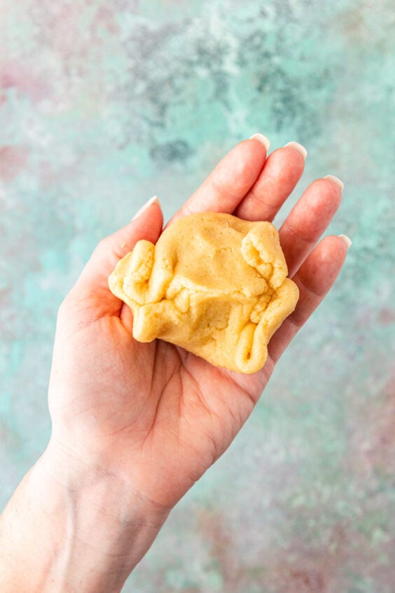 Cookie dough pressed and sealed around filling.