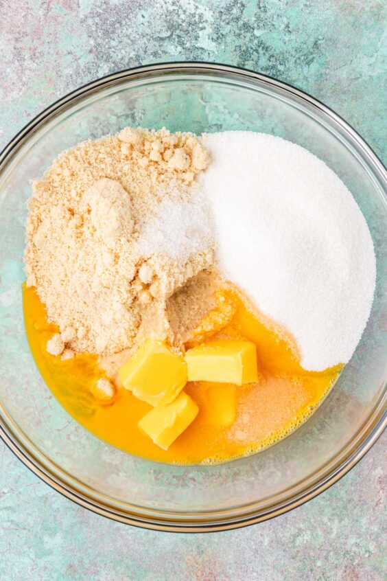 Ingredients to make frangipane filling in a glass bowl ready to be mixed.