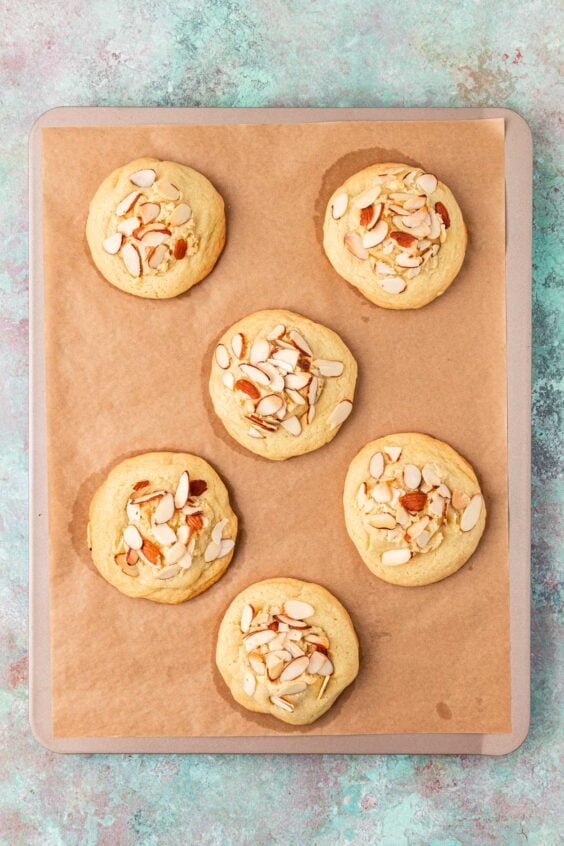Overhead of almond croissant cookies on a baking sheet.