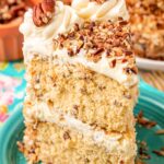 A slice of Italian Cream Cake on a teal plate.