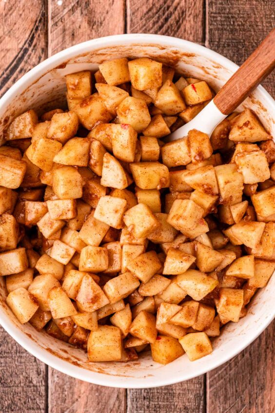 Chopped apples coated in sugar, cinnamon, and flour.