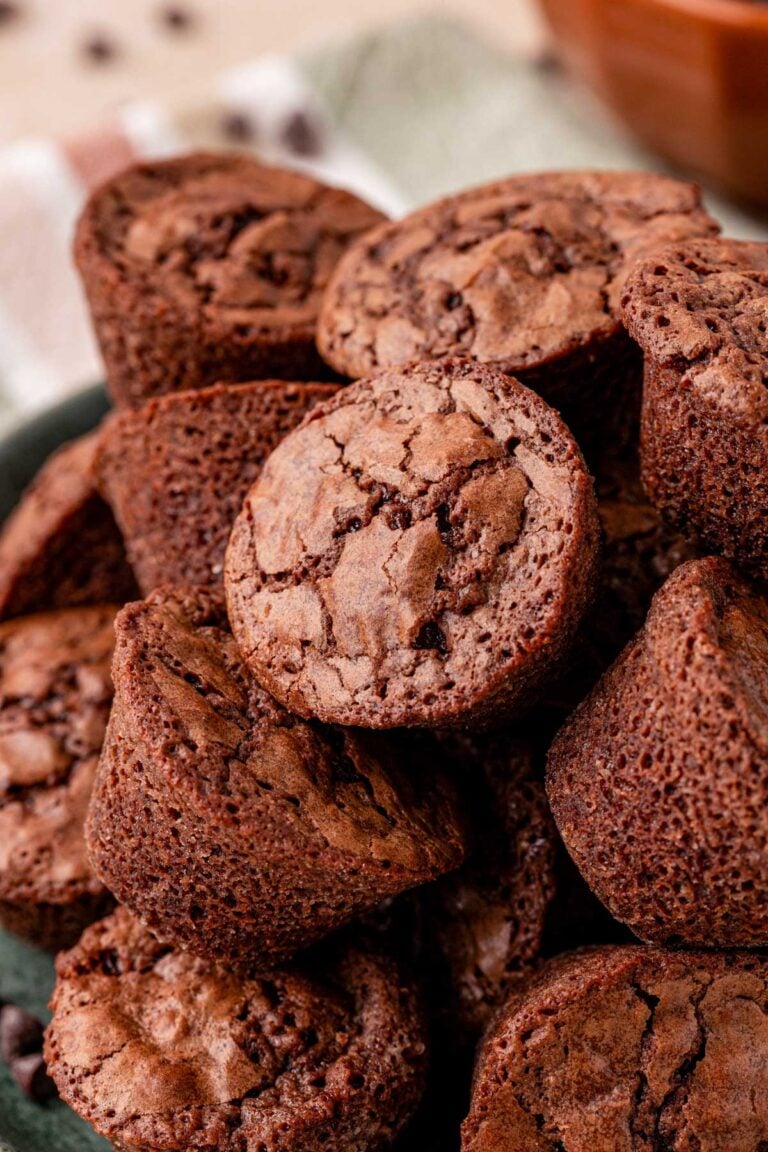 Close up of homemade brownie bites piled on a plate.