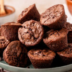 A green plate filled with brownie bites.